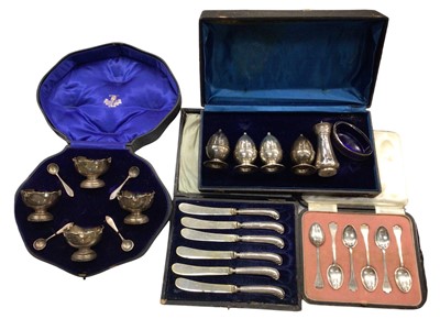 Lot 1010 - Cased set of four silver salts with salt spoons, other silver condiments, set of six silver teaspoons and set of six silver handled butter knives, both in fitted cases