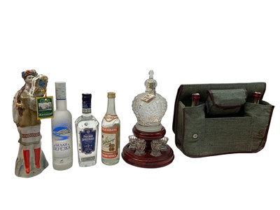 Lot 394 - Mixed group of Russian vodkas to include an Imperial Crown shaped decanter and glasses on stand, three other bottles of Russian vodka, another in the form of a figure in national dress and a canvas...