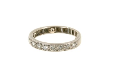 Lot 542 - Diamond eternity ring with a half hoop of eleven brilliant cut diamonds