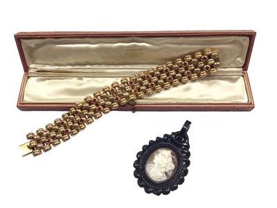 Lot 1004 - Victorian jet and carved shell cameo pendant and an Art Deco yellow metal gem set bracelet (2)