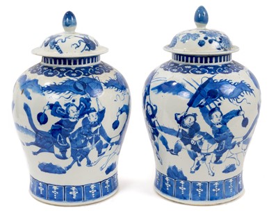 Lot 30 - Pair of 19th century Chinese Kangxi style blue and white baluster vases, decorated with figures, six character marks, with some losses, one with original cover, the other with associated  cover