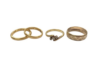 Lot 1017 - Two 22ct gold wedding rings, 18ct gold three stone ring and a 9ct gold wedding ring (4)