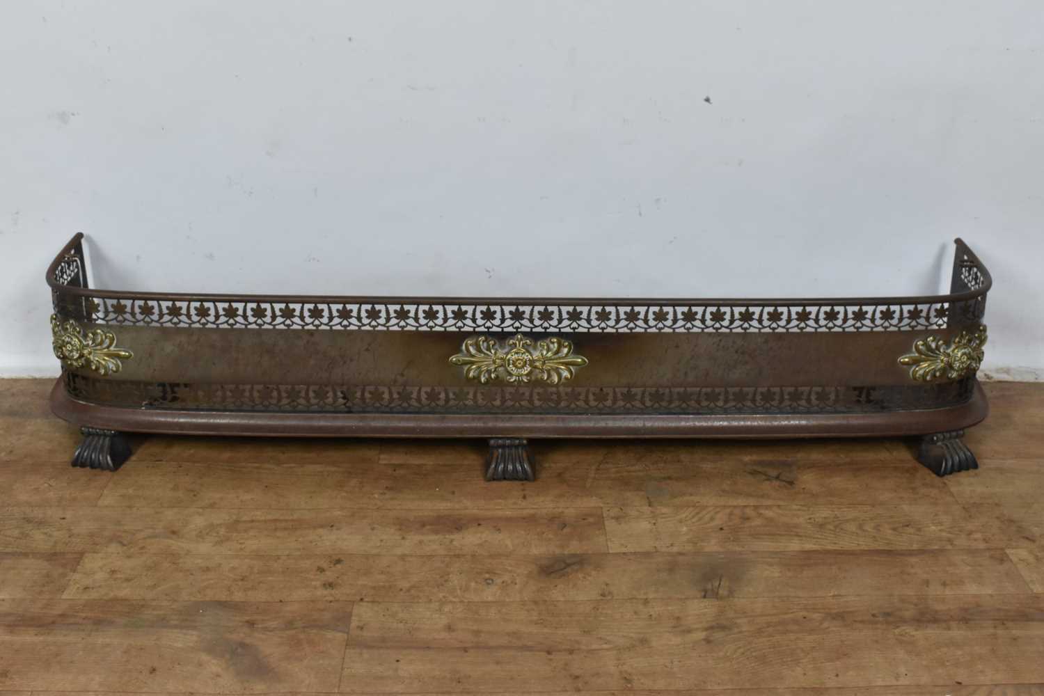 Lot 1464 - Regency steel fire curb with classical brass mounts and pierced decoration