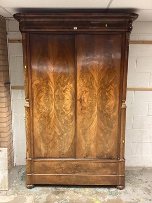 Lot 1326 - Good quality 19th century French Empire revival flame mahogany wardrobe with colomn supports, two doors and two drawers below raised on pad feet