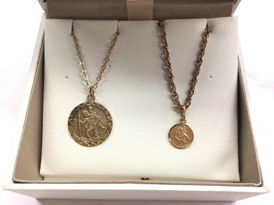 Lot 1033 - Two 9ct gold St. Christopher pendants both on 9ct gold chains