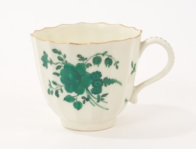 Lot 58 - Worcester faceted coffee cup, with scroll handle, painted in green in the London atelier of James Giles with flowers and leaves, the handle picked out in gilt, 2 ¼” high, circa 1770