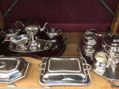 Lot 707 - Edwardian silver plated three piece tea set, one other silver plated tea set, two-handled tray, two entre dishes, sauce boat, sugar caster and a dish