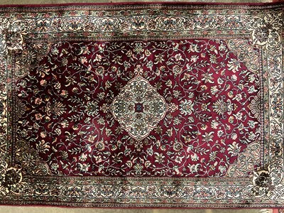 Lot 1456 - Two good quality Persian silk rugs together with a part silk rug (3)