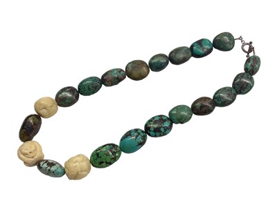 Lot 1080 - Vintage turquoise bead necklace with three carved bone beads depicting oriental mythical creatures