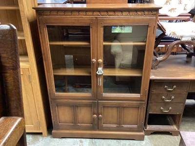 Lot 1250 - Ercol-style elm bookcase with two glazed doors and two panelled doors below 138cm high, 101cm wide, 30.5 cm deep