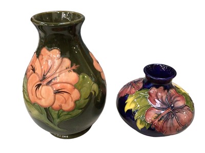 Lot 347 - Two Moorcroft pottery vases decorated in the Hibiscus pattern