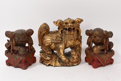 Lot 874 - Antique Chinese carved gilt Buddhist lion and pair of carved guardians