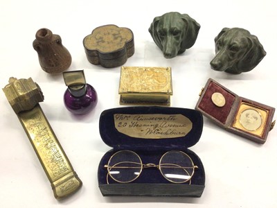 Lot 380 - Victorian brass vesta box in the form of a book, retailed by 'Fisher 188 Strand', Eastern brass pen box, pair of dachshund dog head finials, pair of old spectacles in case and other sundry items