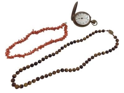 Lot 1092 - Coral necklace, carved tigers eye bead necklace with a Chinese silver filigree clasp and an Edwardian pocket watch (3)