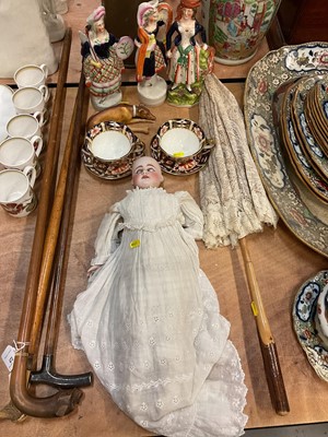 Lot 473 - Three Victorian Staffordshire pottery figures, Victorian bisque porcelain doll, vintage parasol, Royal Crown Derby Imari pattern cups and saucers