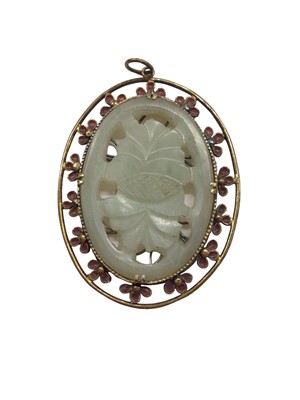 Lot 1035 - Chinese jade/ green hard stone carved oval plaque in yellow metal pendant mount with enamelled decoration, 5cm x 4cm overall