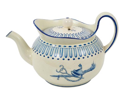 Lot 140 - Wedgwood Queensware small teapot and cover, painted in bright blue enamel with military trophies, circa 1815-20