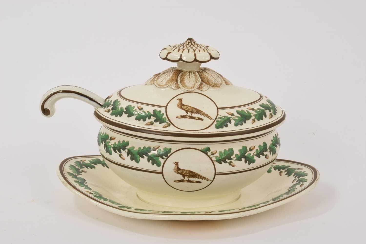 Lot 130 - Wedgwood Queensware crested sauce tureen, cover and fixed stand, circa 1800, and a ladle