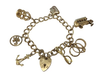 Lot 46 - 9ct gold charm bracelet with padlock clasp and seven novelty charms
