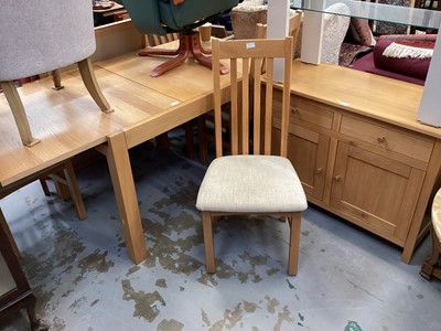 Lot 1331 - Contempory oak extending dining table, four chairs, sideboard and modern glass and metal framed side table