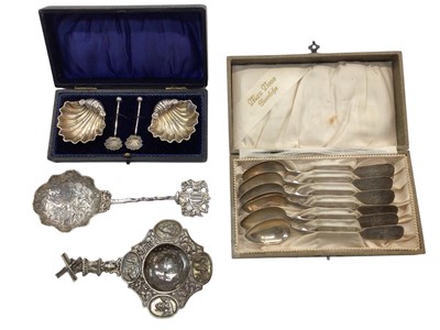 Lot 1063 - Pair of silver shell shaped salts with spoons in fitted case, set of six silver (800) teaspoons in case and two Dutch white metal tea strainers