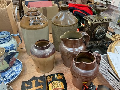 Lot 488 - Two salt glazed stoneware flagons, together with two salt glazed stoneware jugs and a tobacco jar.