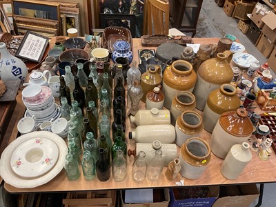 Lot 495 - Group of salt glazed flagons, jars, hot water bottles, glass bottles and teaware.