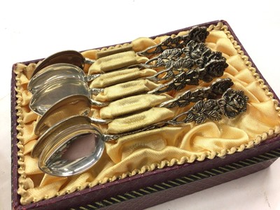 Lot 1099 - Silver framed desk calendar, tea strainer stamped 'sterling', set of six silver (835) coffee spoons with rose decoration, silver handled button hook and a silver collared glass scent bottle