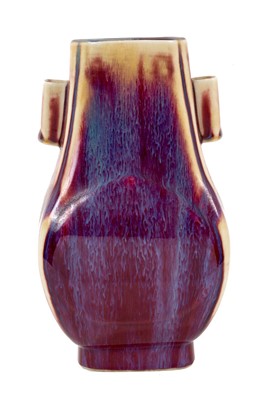 Lot 1 - A Chinese sang-de-boeuf vase, of Hu form with arrow handles, with a streaked red and purple glaze, 19th/20th century, 21.5cm high