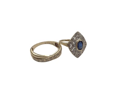 Lot 1017 - Art Deco style sapphire and diamond ring with a pierced plaque centred with a blue sapphire, in 14ct gold setting, together with a 9ct gold and diamond cross-over ring (2)