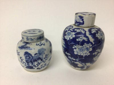 Lot 3 - Two 19th century Chinese blue and white ginger jars and covers, one decorated with foo dogs and the other with prunus blossom and other foliage, 9.5cm and 14.5cm high