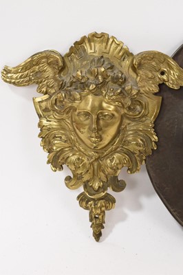 Lot 838 - Pair of large 19th century ormolu furniture mounts, in the form of angel masks, 20cm high, together with a Newlyn type copper dish, and a framed 18th century textile fragment