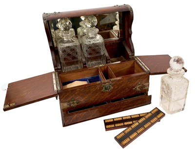 Lot 887 - Edwardian oak and metal mounted tantalus and games compendium