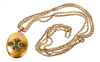 Lot 535 - Victorian gold emerald and seed pearl oval locket on a Victorian 9ct gold guard chain