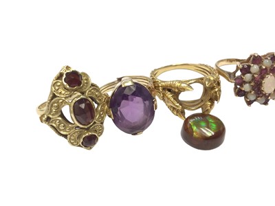 Lot 82 - 14ct gold antique-style garnet three stone cocktail ring, yellow metal amethyst ring, yellow metal claw ring with iridescent opal-like stone (loose) and three 9ct gold gem set dress rings (6)
