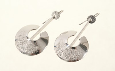 Lot 672 - Pair of 18ct white gold diamond set pendant disc earrings by Christopher Lawrence (London 1988), 45mm drop