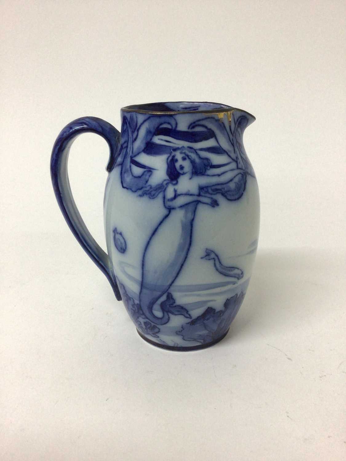 Lot 43 - Early 20th century Royal Doulton flow blue jug decorated in the Art Nouveau style with mermaids and fish, stamped mark, 15cm high