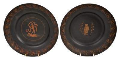 Lot 45 - An unusual pair of Basalt pottery dishes, possibly late 18th century Wedgwood, decorated in the Etruscan style, one with a figure standing on a dolphin, the other with an owl, feathered edges, 22.5...