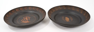 Lot 45 - An unusual pair of Basalt pottery dishes, possibly late 18th century Wedgwood, decorated in the Etruscan style, one with a figure standing on a dolphin, the other with an owl, feathered edges, 22.5...