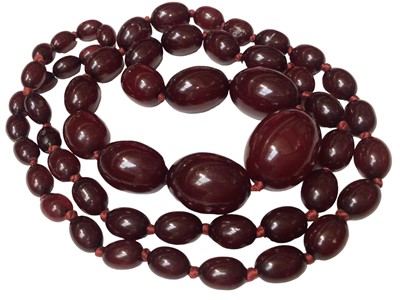 Lot 178 - Simulated cherry amber graduated oval bead necklace
