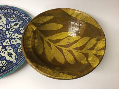 Lot 50 - Two Eastern slipware pottery dishes, possibly Afghan, together with a large ewer and an Iznik style dish (4)