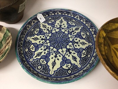 Lot 50 - Two Eastern slipware pottery dishes, possibly Afghan, together with a large ewer and an Iznik style dish (4)