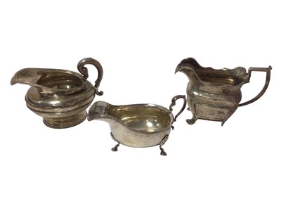 Lot 276 - Irish silver cream jug, silver sauce boat and a silver cream jug (3)