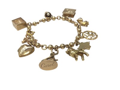 Lot 71 - 9ct gold bead and chain link charm bracelet with nine various charms