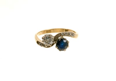 Lot 512 - Edwardian diamond and sapphire two stone cross over ring