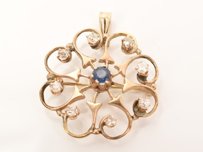 Lot 601 - Sapphire and diamond flower shaped pendant/brooch