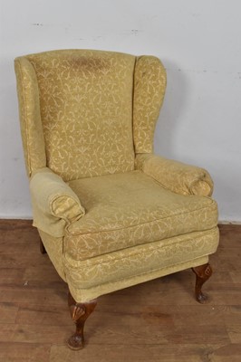 Lot 1257 - Queen Anne style wing armchair, raised on shell capped cabriole legs