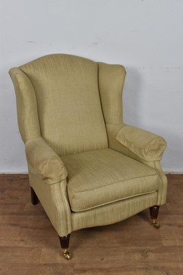 Lot 1261 - Laura Ashley wing armchair, raised on fluted legs and castors