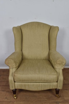 Lot 1261 - Laura Ashley wing armchair, raised on fluted legs and castors