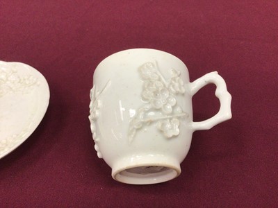 Lot 56 - Bow blanc de chine cup and saucer, circa 1752, decorated in relief with prunus blossom, crabstock handle, the saucer 11.5cm diameter
